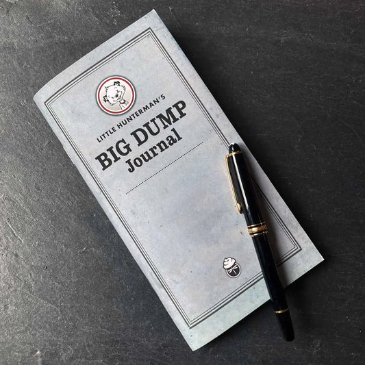 Little Hunterman's Big Dump Journal – dotted edition – lying on a desk with a fountain pen.