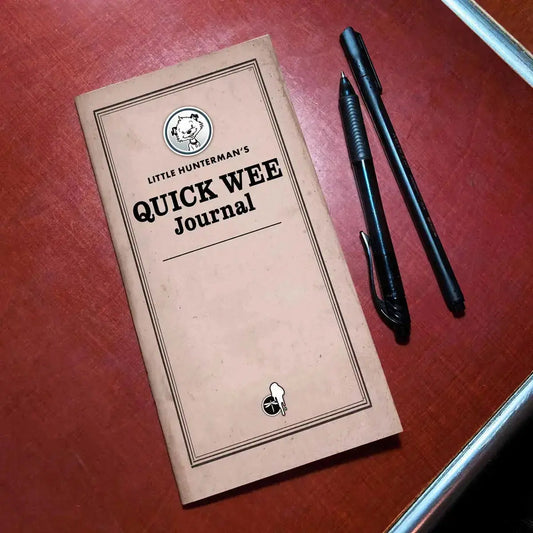 Little Hunterman's Quick Wee Journal lying on a desk next to pens