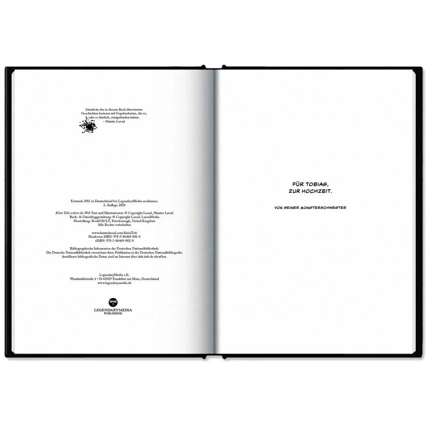 This image shows the hardcover of "Klein Tobi erobert die Welt: lauter wahre (Monster-)Geschichten" by Hunter Lassal on a white surface. The book is open on the imprint and dedication.