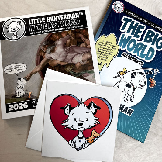 A calendar, a book, and a large card featuring a cartoon dog character on a light wooden surface.