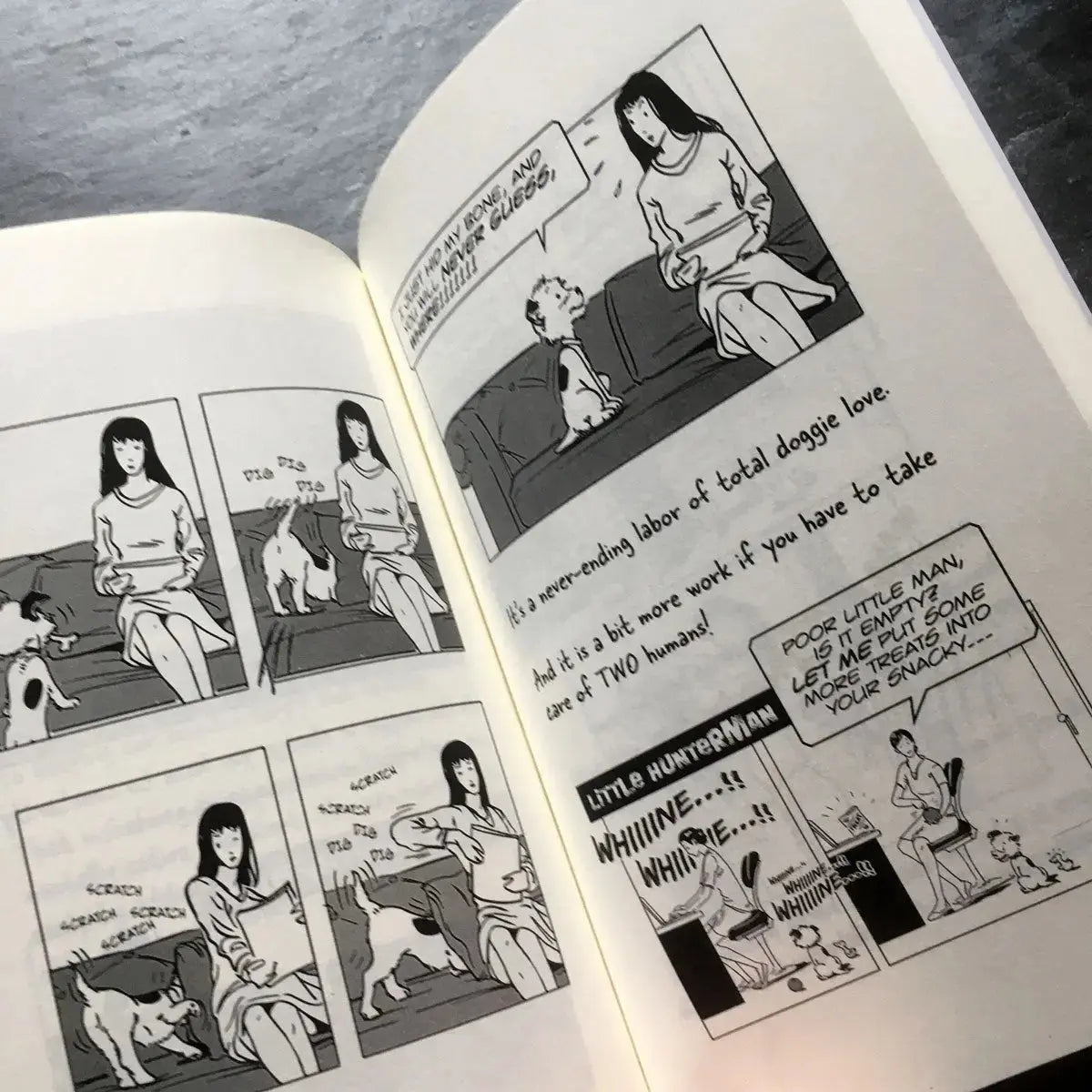 The Big World According to Little Hunterman, retailer version hardcover with black and white illustrations and creme colored paper. This images shows an open book on a table giving you a glimpse of two illustrated content pages.