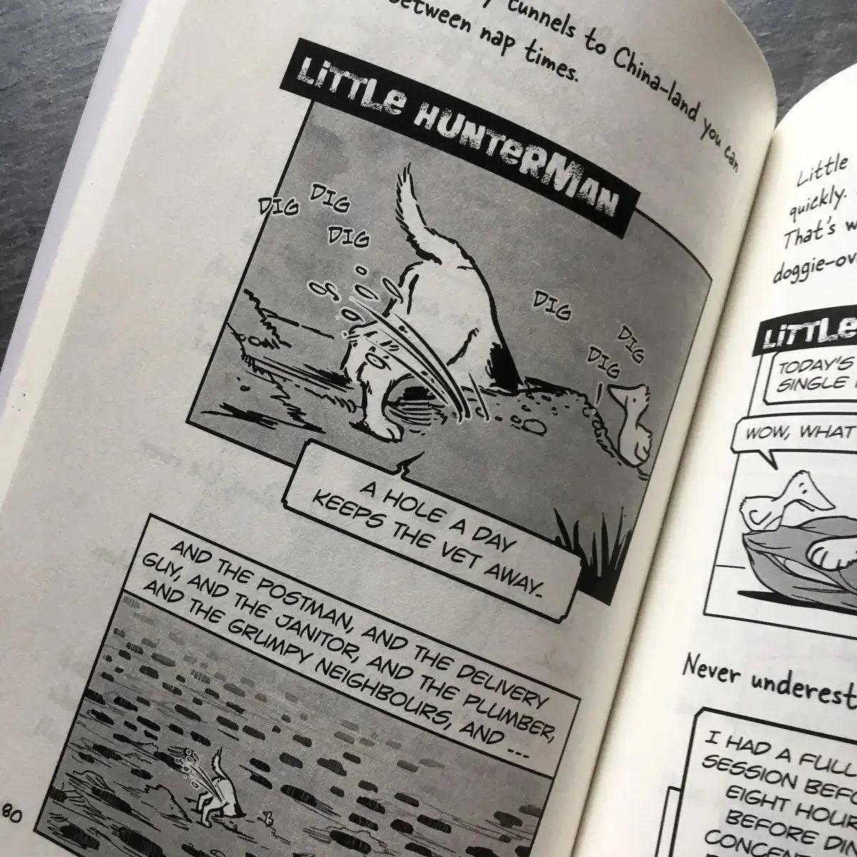 The Big World According to Little Hunterman by Hunter Lassal, retailer version with black and white illustrations and creme colored paper. This image shows an open book on a table giving you a glimpse of the illustrated content pages.