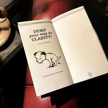 An open dotted version of a Little Hunterman's Dump-Journal showing an annotation page and one doggie dump-quote: "Dump your way to clarity!"