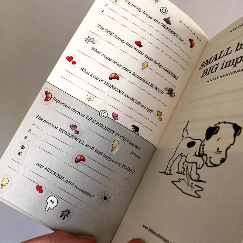 A sample page of Little Hunterman's Quick Wee Journal, decorated with stickers from Sticker Sheets 1 and 2. It shows how having the stickers on clear material helps by not covering up the journal beyond the illustrations themselves. Meanwhile, the illustrations come with a white backing to let them pop out more on the page.