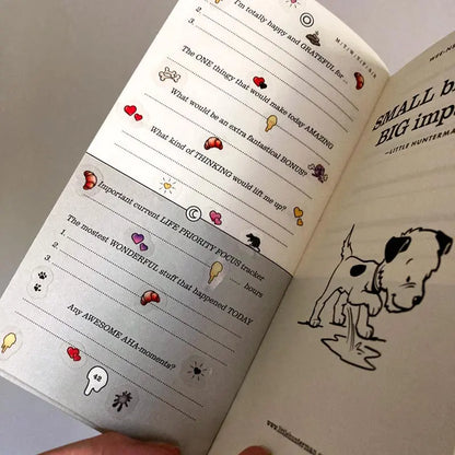 A sample page of Little Hunterman's Quick Wee Journal, decorated with stickers from Sticker Sheets 1 and 2. It shows how having the stickers on clear material helps by not covering up the journal beyond the illustrations themselves. Meanwhile, the illustrations come with a white backing to let them pop out more on the page.