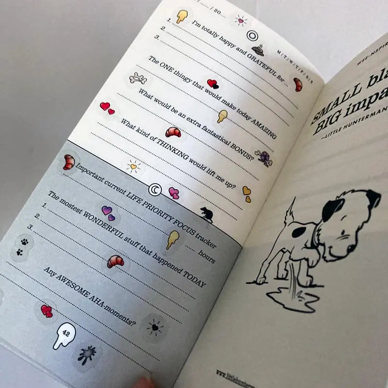A sample page of Little Hunterman's Quick Wee Journal, decorated with stickers from Sticker Sheets 1 and 2. It shows how having the stickers on clear material helps by not covering up the journal beyond the illustrations themselves. Meanwhile, the illustrations come with a white backing to let them pop out more on the page.