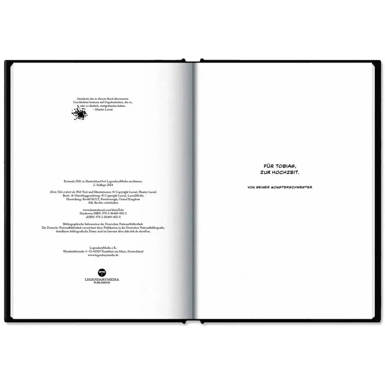 This image shows the hardcover of "Klein Tobi erobert die Welt: lauter wahre (Monster-)Geschichten" by Hunter Lassal on a white surface. The book is open on the imprint and dedication.