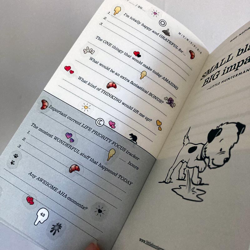 A sample page of Little Hunterman's Quick Wee Journal, decorated with stickers from Sticker Sheets 1 and 2. It shows how having the stickers on clear material helps by not covering up the journal beyond the illustrations themselves. Meanwhile, the illustrations come with a white backing to let them pop out more on the page.