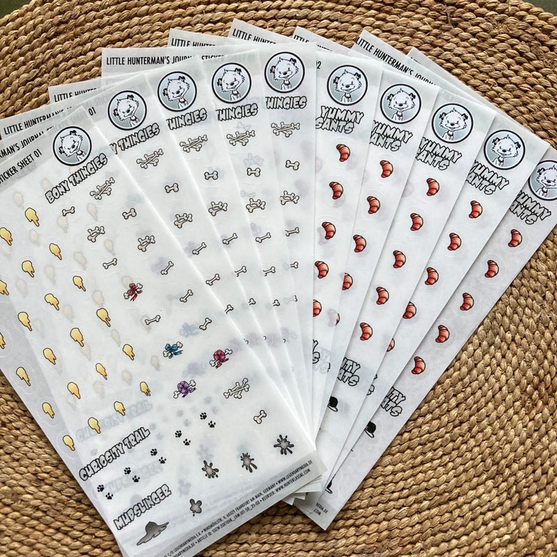 10 Little Hunterman Journal Sticker sheets, lying on a table. 5 of each design.