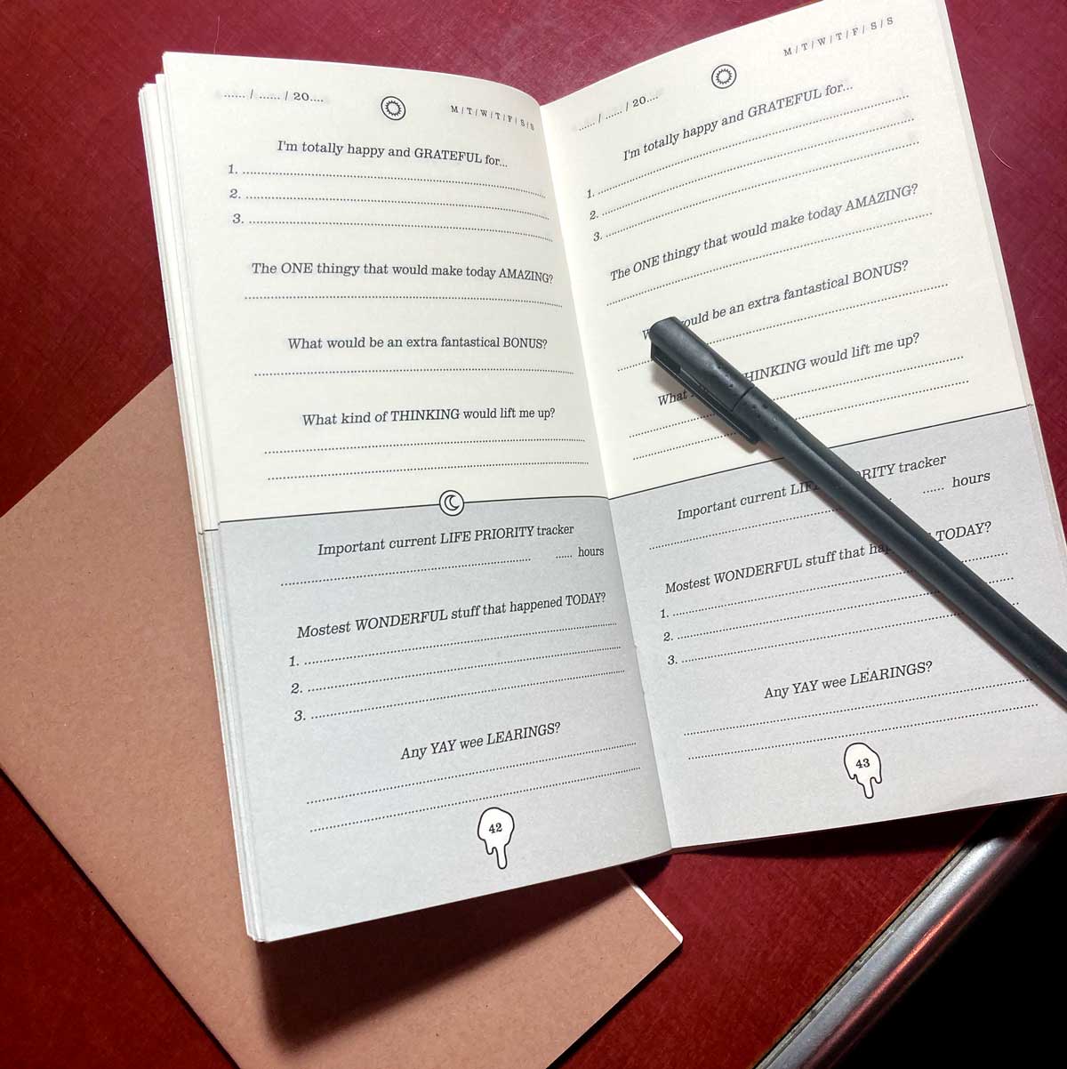 Little Hunterman's Quick Wee Journal lying open on a desk with a pen.