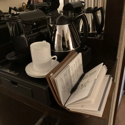 Hotel room picture showing Little Hunterman's Quick Wee Journal sitting next to the coffee maker. A nice way to start the day – no matter where you are.