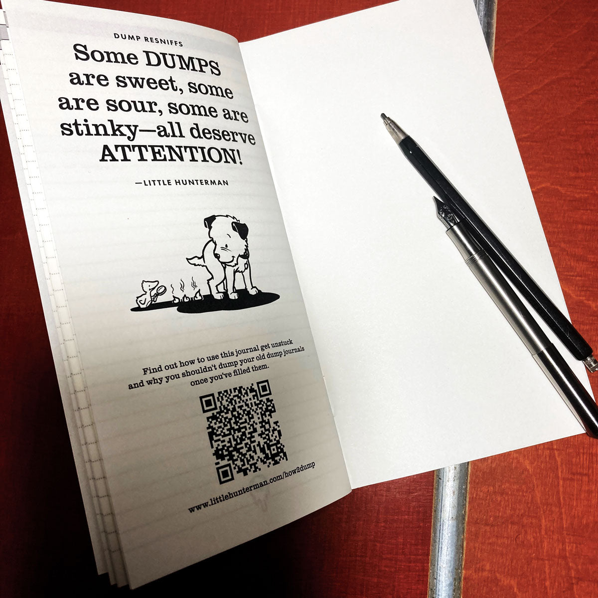 Little Hunterman's lined Dump-Journal open on a desk showing the last page with a doggie dump-quote and the QR-code to an explanatory page.