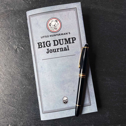 Little Hunterman's Big Dump Journal lying on a desk with a fountain pen.