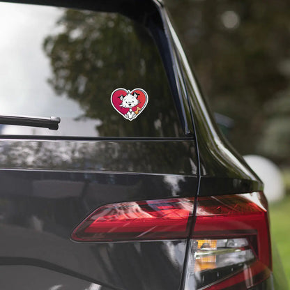 Image shows part of the back of a black car with one of Little Hunterman's "Sticky Doggie Love" stickers attached to the bottom corner of the back window. 