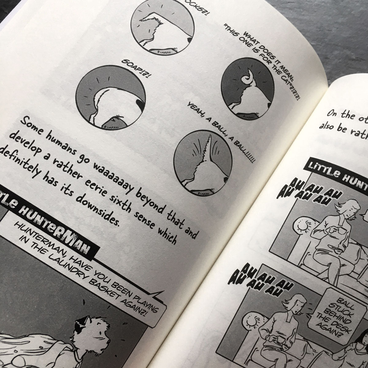 The Big World According to Little Hunterman by Hunter Lassal, retailer version with black and white illustrations and creme colored paper. This image shows an open book on a table giving you a look inside on the illustrated content pages.