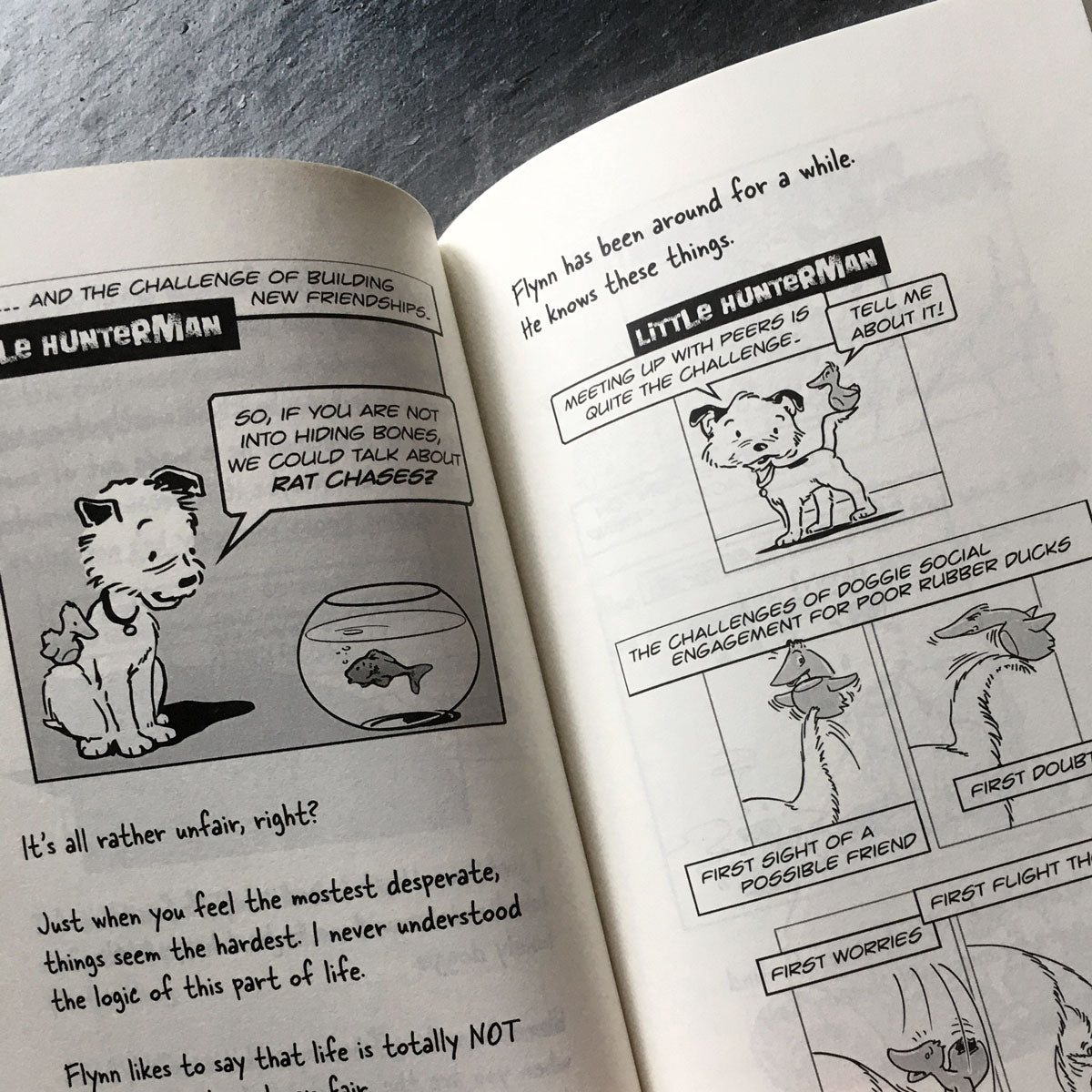 The Big World According to Little Hunterman, retailer version hardcover with black and white illustrations and creme colored paper. This images shows an open book on a table giving you a glimpse of the illustrated content pages.