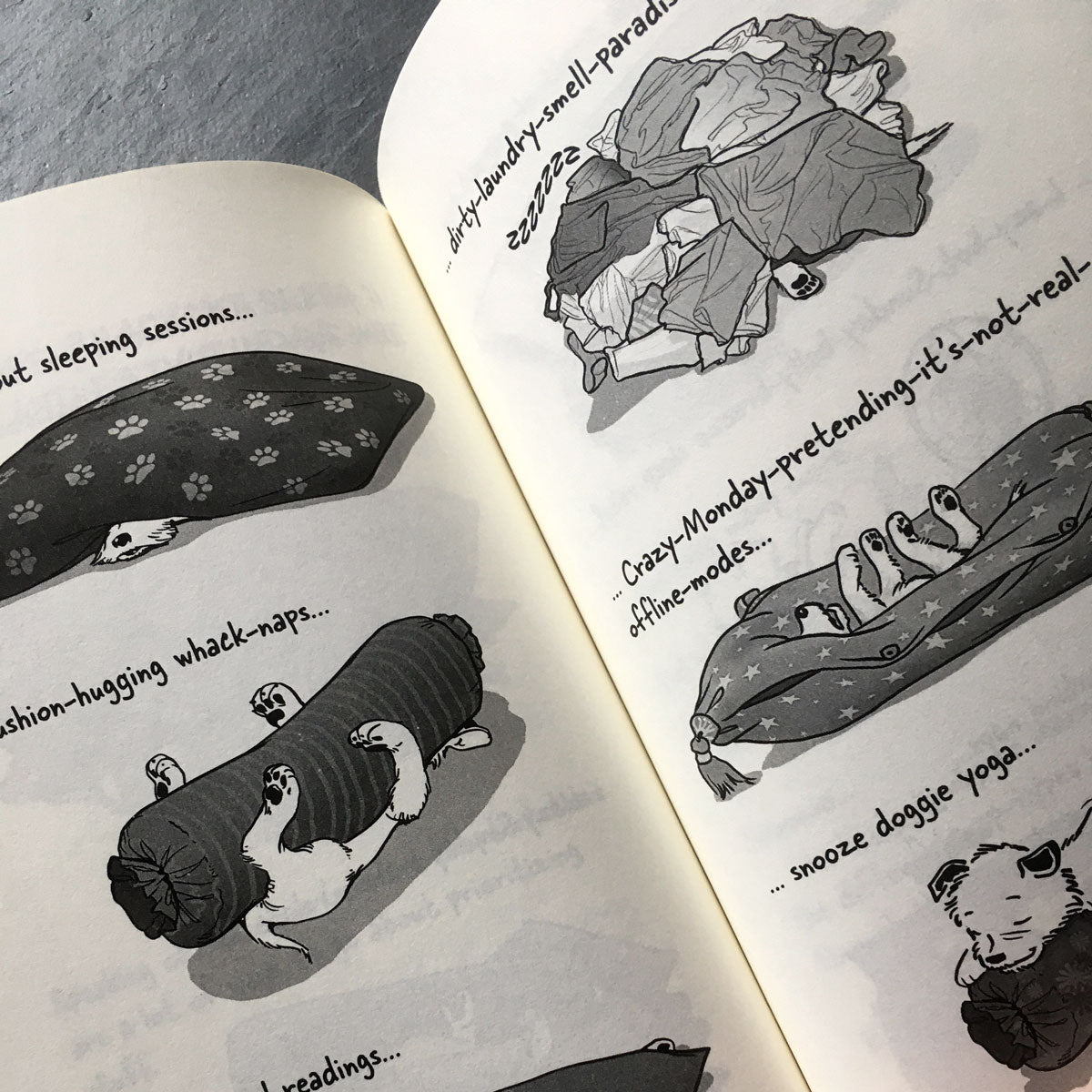 The Big World According to Little Hunterman, retailer version hardcover with black and white illustrations and creme colored paper. This images shows an open book on a table giving you a glimpse of the illustrated content pages.